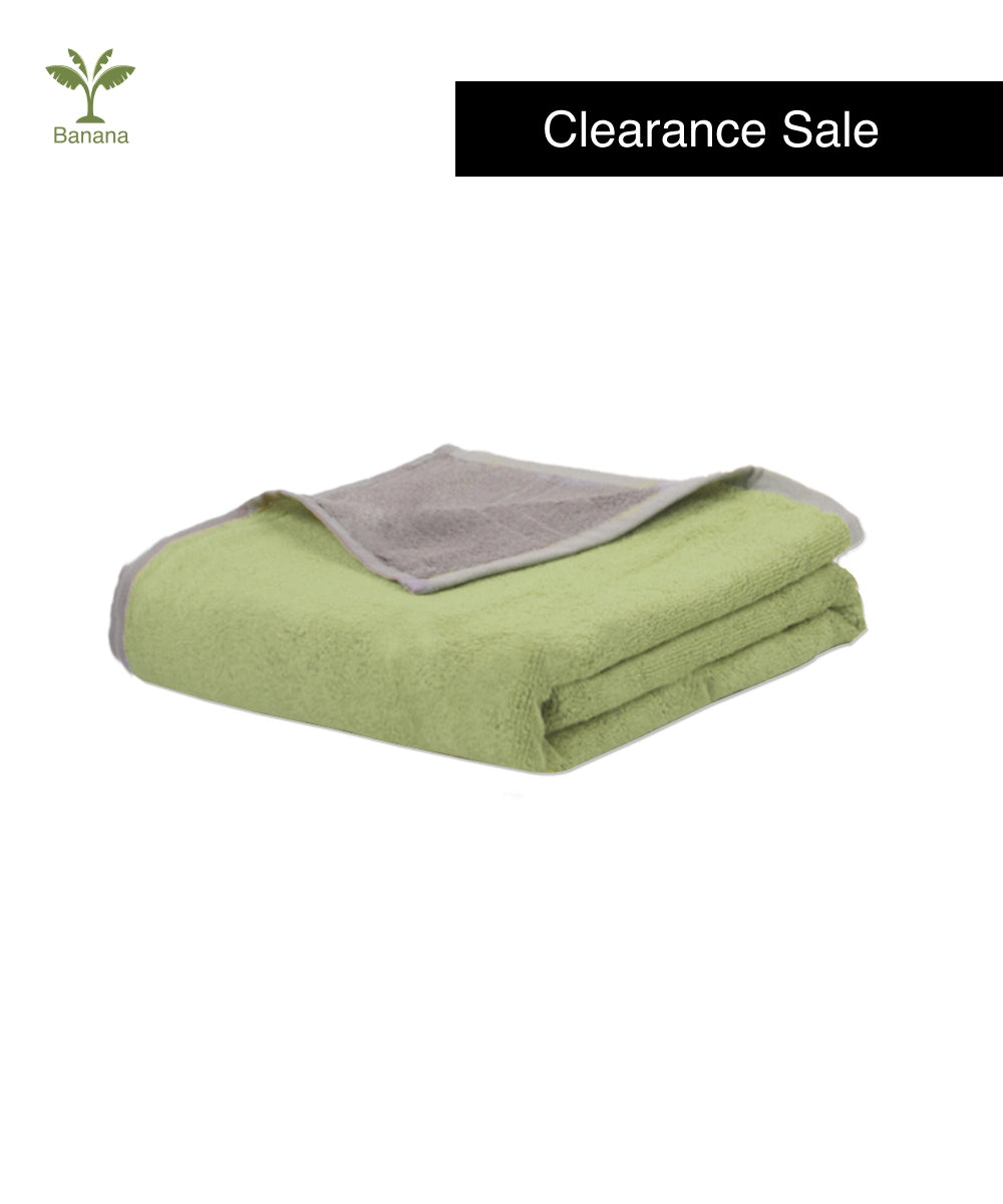 Folded green blanket with gray lining on a white background, featuring 'Banana' brand logo.
